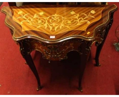 A contemporary French style mahogany floral inlaid and gilt metal mounted serpentine front side table, width 101cmCondition r