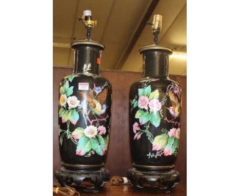 A pair of floral painted ceramic table lamps, the fixed bases in the Chinese taste, each height (including fittings) 62cm