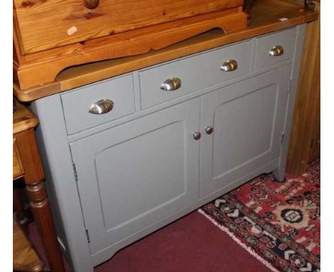 A contemporary light oak and grey painted double door side cupboard having three upper drawers, width 117cmCondition report: 