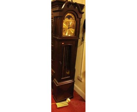 A contemporary mahogany longcase clock, having arched brass moonphase dial, glazed trunk door, with pendulum and three weight