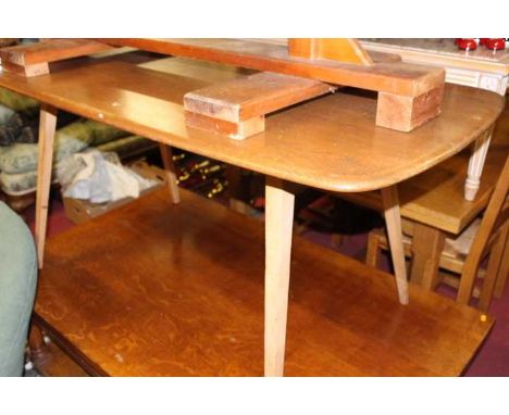 An Ercol light elm dining table, raised on tapering supports, length 152cm