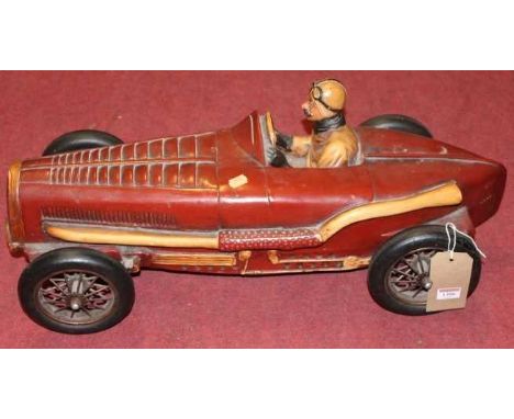A contemporary painted hardwood model racing driver, length 72cm