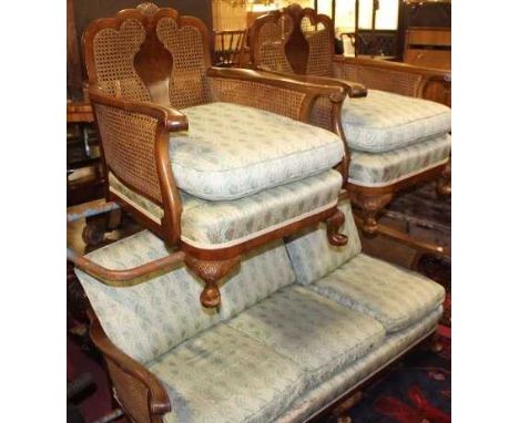 A 1920s walnut and double split cane inset three-piece Bergere suite, comprising; three-seater sofa and pair of armchairs, ea