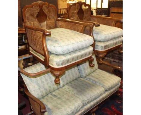 A 1920s walnut and double split cane inset three-piece Bergere suite, comprising; three-seater sofa and pair of armchairs, ea