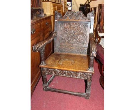 An antique relief carved oak panelled seat armchair, width 62cmCondition report: Panel to back has a horizontal split.Two rin