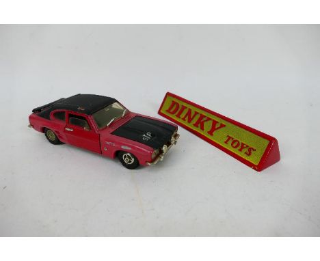 Dinky - An unboxed Ford Capri 3.0 Litre Rally car in 1:25 scale # 2214 and a cast metal Dinky desk sign. The car shows signs 