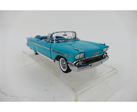 Franklin Mint - A boxed 1958 Chevrolet Impala Convertible in 1:24 scale. The model appears Mint in its original packaging. (T