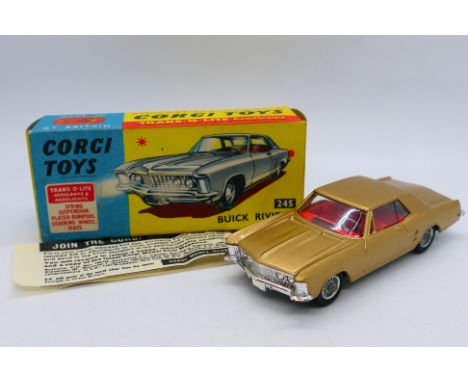 Corgi - A boxed Buick Riviera in gold # 245. The model appears Near Mint but the tow hook has broken off. The box is Very Goo