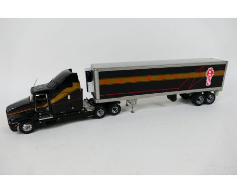 Franklin Mint - An unboxed American Kenworth semi truck in black, silver and gold in 1:32 scale with removable cab roof. The 