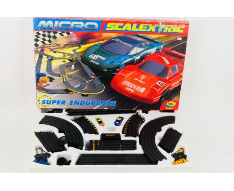 Scalextric - A boxed Micro Scalextric 'Super Endurance' set. The set contains two cars, a quantity of track, two controllers,