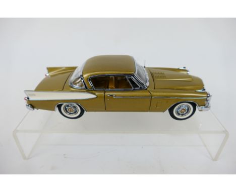 Franklin Mint - A boxed 1957 Studebaker Golden Hawk in 1:24 scale. The model appears Mint in its original packaging. (This do