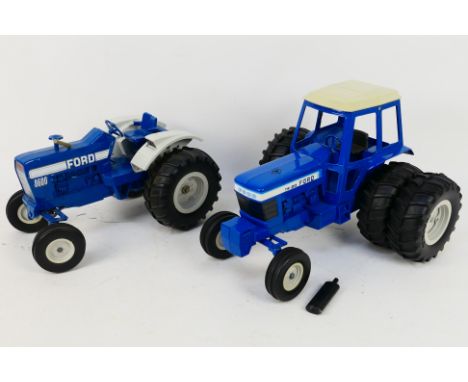 Ertl - Two unboxed 1:12 scale diecast Ford tractors from Ertl. Lot contains a Ford 8600 with a Ford TW-20 double rear wheel t