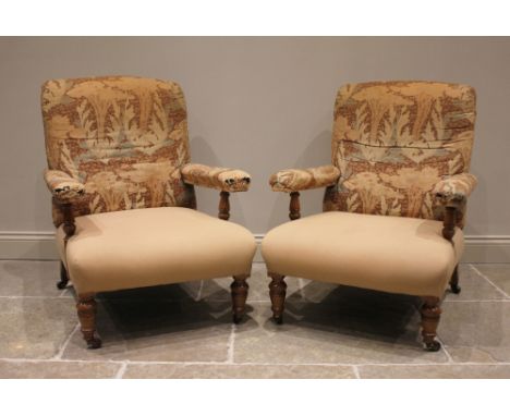 A pair of Victorian lounge armchairs in the manner of Howard & Sons, partially covered in Liberty-esque fabric, the upholster