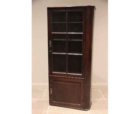 A 19th century mahogany freestanding bookcase, rounded to the right hand side, the single glazed door opening to three shelve