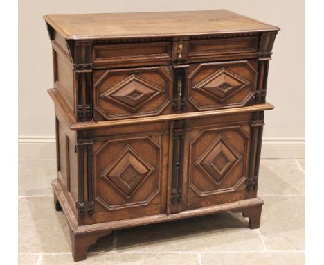 A Jacobean oak two section chest, late 17th century, the moulded and rounded plank top with a dentil frieze over a single fri