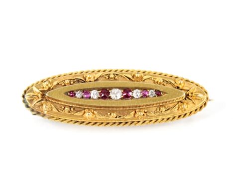 A Victorian ruby and diamond Etruscan style brooch, the central panel set with graduated alternating mixed cut diamonds and m