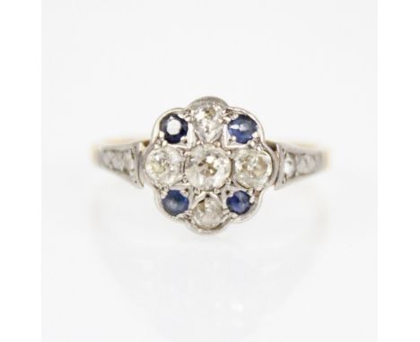 An early 20th century sapphire and diamond floral cluster ring, the central floral head set with five old cut diamonds, inter