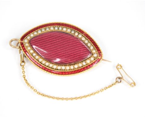 A Victorian pearl and red enamel memorial brooch pendant, of navette form, the central transparent glazed aperture with a sur
