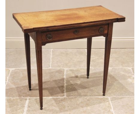 A George III mahogany folding card table, the rectangular hinged top with inlaid stringing and extended corners, above a sing