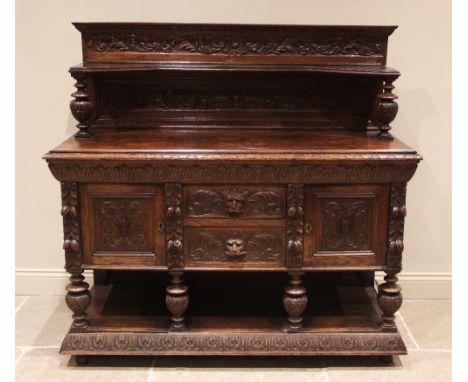 A Victorian carved oak buffet, the superstructure back with carved foliate detail and inverted shelf upon knopped baluster su