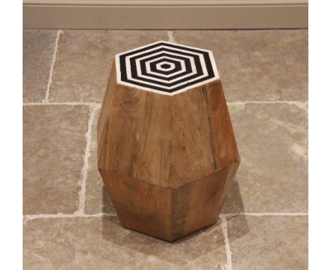 A contemporary hardwood stool or plant stand, of tapering hexagonal form, with a composite black and white radiating top, 49c