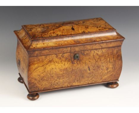 A pollard oak sarcophagus shaped tea caddy, mid 19th century, the velvet lined hinged cover enclosing two removable lidded ca