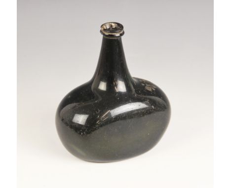 An English 18th century glass wine bottle, of bladder shape and of olive green colour, 17cm highCR; The marks to the shoulder