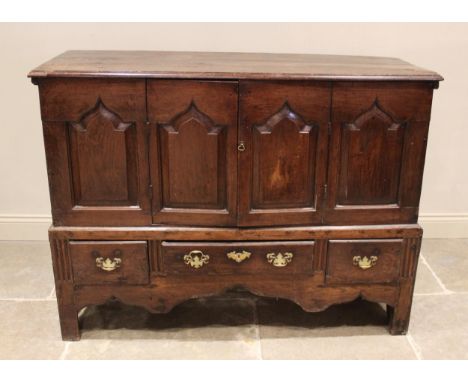 A George III oak mule chest, later converted, the rectangular plank top with a moulded edge above four ogee fielded panels, t