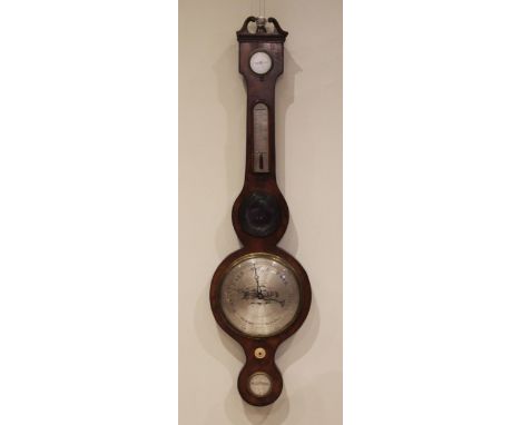 A mid 19th century mahogany wheel barometer by 'Britton Stamford' the swans neck pediment above a silvered dry/damp indicator