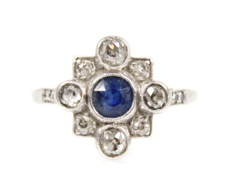 An early 20th century sapphire and diamond transitional ring, the central round mixed cut sapphire measuring 4.5mm diameter, 