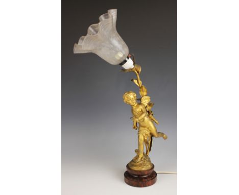 A French gilt effect spelter table lamp, early 20th century, modelled as Cupid or Eros with his arrow, bow and quiver, the la