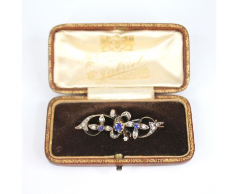 A Victorian sapphire and diamond floral bar brooch, comprising a central round mixed cut sapphire (untested) measuring 4mm di