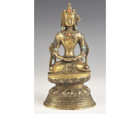 A South East Asian gilt bronze model of Buddha, 19th century, modelled seated in dhyanasana on a double lotus base, with hand