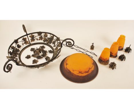 A wrought iron and coloured glass ceiling light fitting, the leafy open work iron frame extending to three scrolled branches 