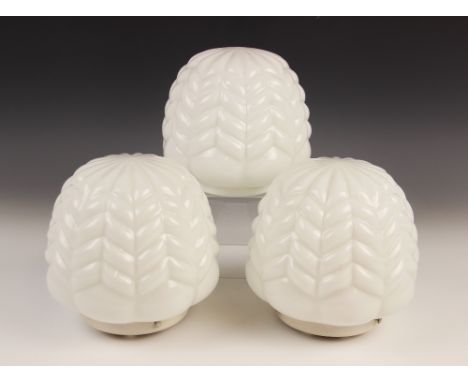 Three matching Art Deco style milk glass pendant lamp shades, of lobed chevron form, each approximately 16cm high and 17cm di