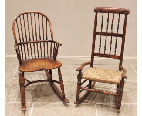 A 19th century style hoop back ash Windsor rocking chair, 20th century, the stick back above a saddle shaped seat, upon turne