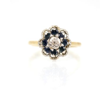 An early 20th century sapphire and diamond floral cluster ring, the central single cut diamond set to a gypsy star surround, 