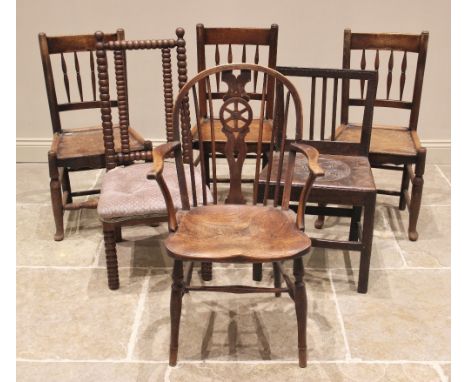 Three 18th century elm spindle back country chairs, each with four tapering spindles above a figured elm seat and a shaped ap