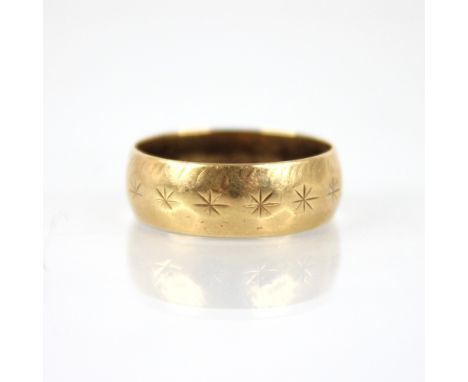 An 18ct wedding band, star cut detail to band, marks for S &amp; W, London 1965, ring size L 1/2, weight 3.9gms 