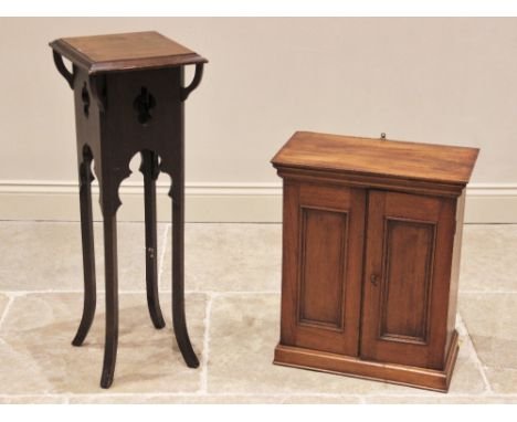 An Edwardian walnut wall cabinet, with a pair of panelled doors opening to two shelves, upon a plinth base, 59cm H x 50cm W x