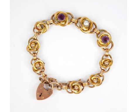 An Arts & Crafts gold coloured amethyst and pearl set bracelet, designed as interwoven knot links, two set with round mixed c