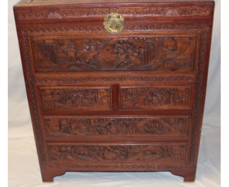 An Eastern carved camphor wood rectangular combination trunk/chest decorated all over with various figures and landscapes, th