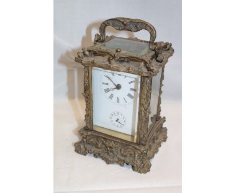 A good quality French chiming carriage clock with rectangular enamelled dial in ornate brass traditional case