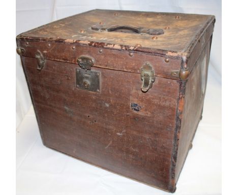 An old brass mounted travelling trunk with leather handle and original travel label, 17" x 20" wide