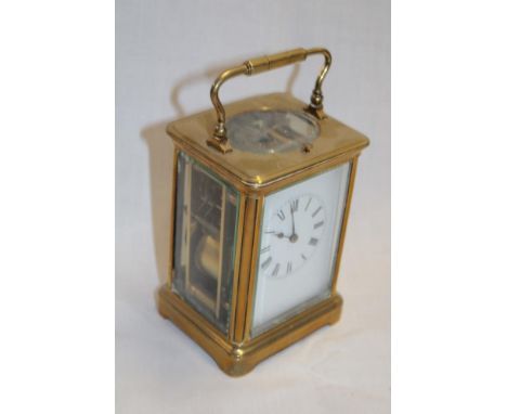 A good quality French carriage clock with rectangular enamelled dial in brass traditional glazed case