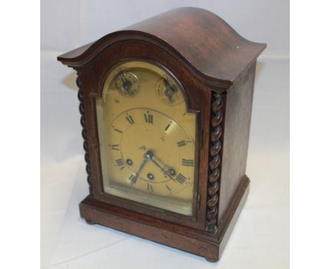 A 1930's Westminster chiming mantel clock with brass arched dial in oak traditional case, 11½" high