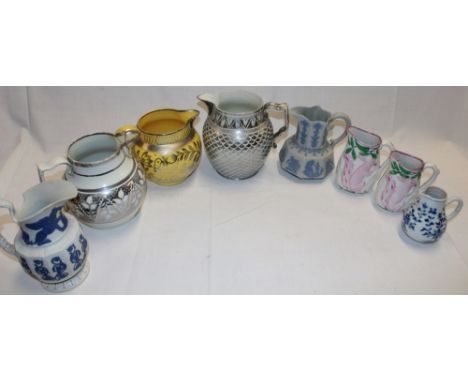 A selection of 19th century pottery jugs including small blue and white tapered jug with floral decoration, 4" high; a pair o