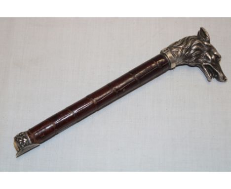 A Continental silver walking stick top in the form of a dog's head with glass eyes