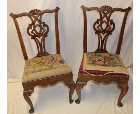 A pair of George III oak Chippendale-style dining chairs with pierced vase splat-backs and tapestry upholstered seats on cabr