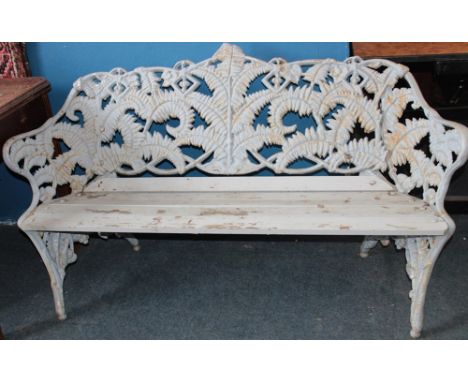 A 19th century cast-iron garden bench, possibly Coalbrookedale, with fern leaf decoration back and wooden slatted seat, 59" l